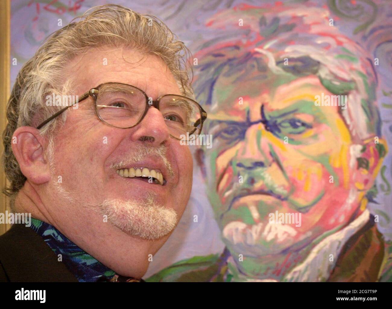 Artist Rolf Harris stands in front of his self-portrait painting at the National Gallery, London. Rolf will have some of his works based on well-loved masterpieces such as Monet's Waterlilies and Van Gogh's Sunflowers go on show at the London gallery until December 2nd. Stock Photo