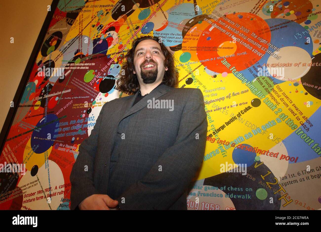 33-year-old Keith Tyson with his piece 'Bubble Chambers' after winning the 2002 Turner prize at the Tate Britain Gallery, London. Mr Tyson, *..known for casting the entire contents of a Kentucky Fried Chicken menu in lead at the behest of a computer landed the prize for his science-inspired works - yet despite gaining renown for some of his wackier stunts, his victory was a rare Turner triumph for a painter. He had been favourite to take the 20,000 prize after displaying a vivid collection of thought-provoking works at the Turner exhibition at Tate Britain, where the award was made at a rec Stock Photo