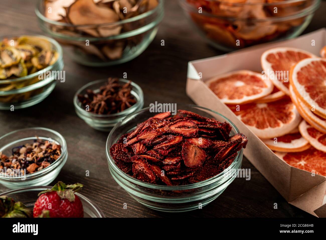 Close-up of various dried fruits in bowls placed on table and ready for packaging Stock Photo
