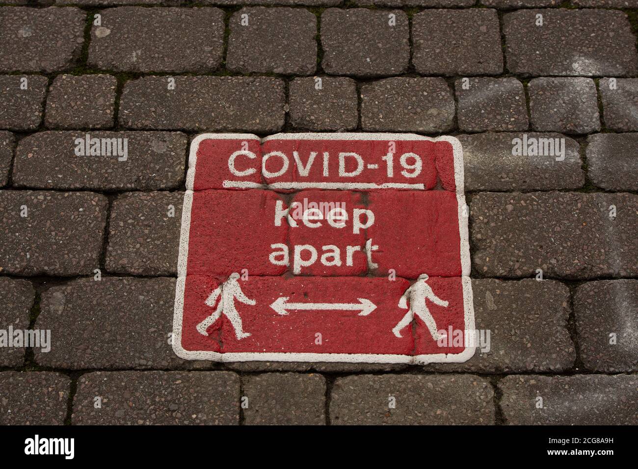 Bolton City Centre during new lockdown rules. Covid-19 sign reminding public to keep apart. Social distancing sign on the floor. 2020 Stock Photo