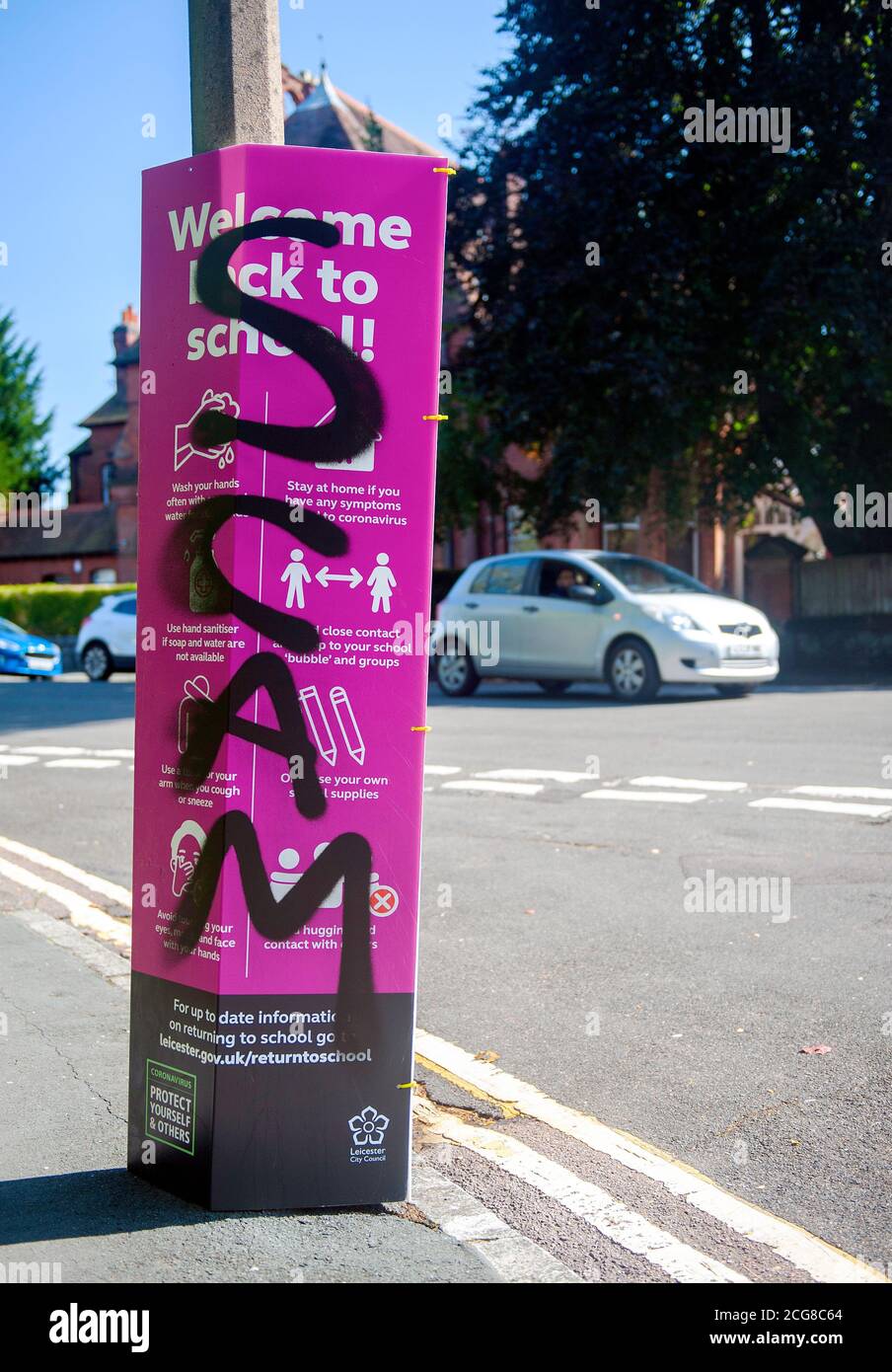 Coronavirus denial defaced local council guidance hoardings near schools. Stock Photo