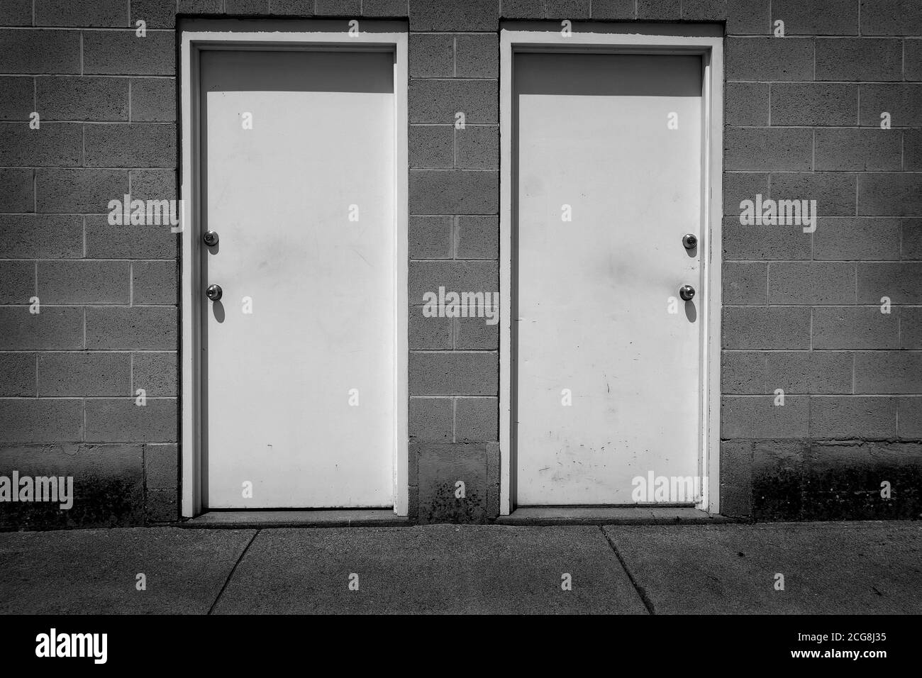 Two white doors with handles representing choices and options in life