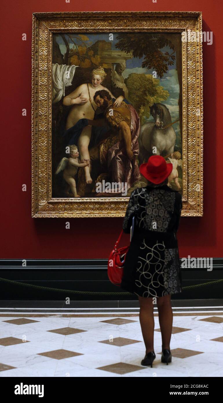 A visitor looks at Mars and Venus United by Love by Paolo Veronese, during a press preview for the Veronese: Magnificence in Renaissance Venice exhibition at the National Gallery, London. Stock Photo