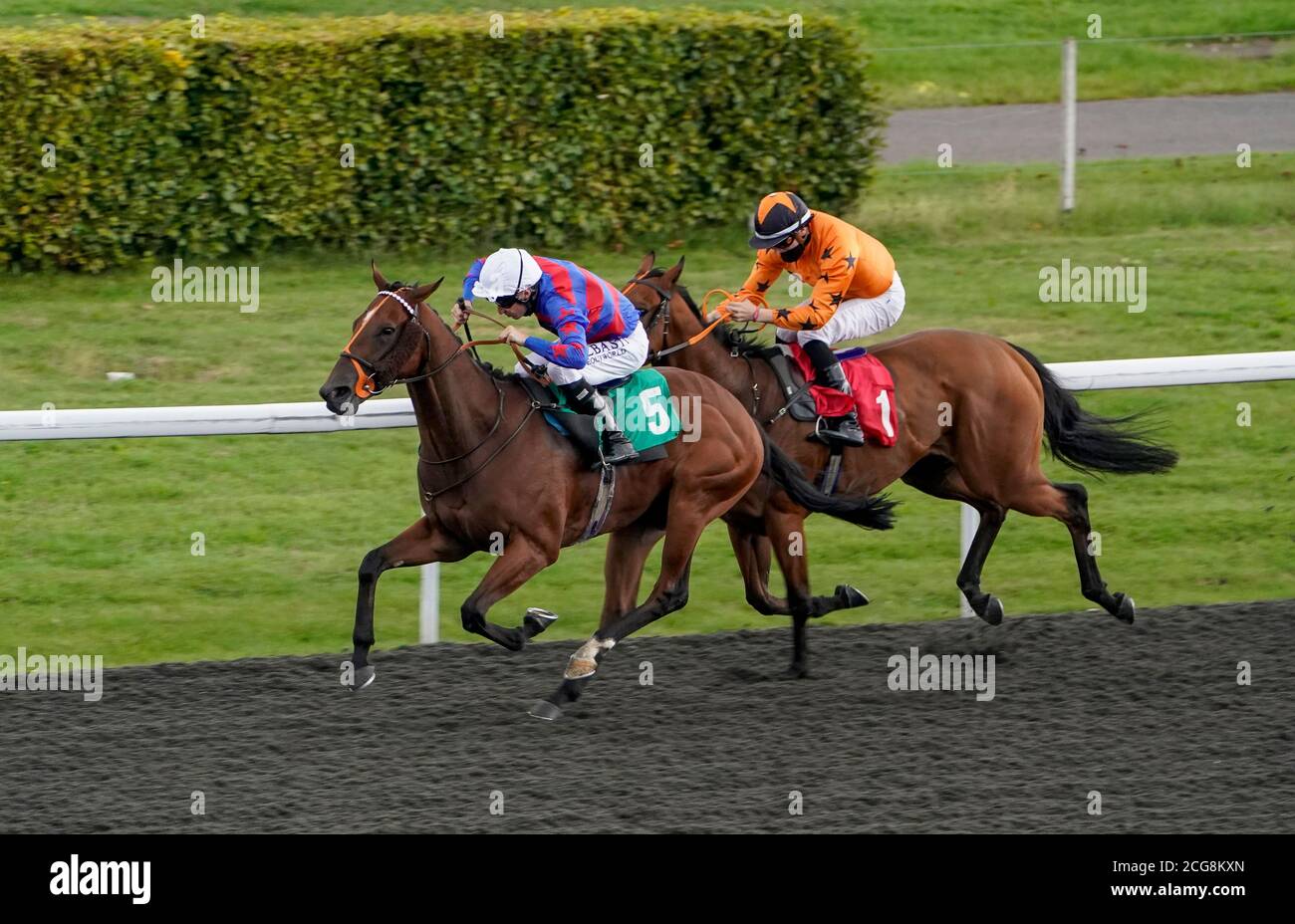 Limaro Prospect ridden by Luke Morris (left) win The Try Our New Price Boosts At Unibet Handicap at Kempton Park Racecourse. Stock Photo