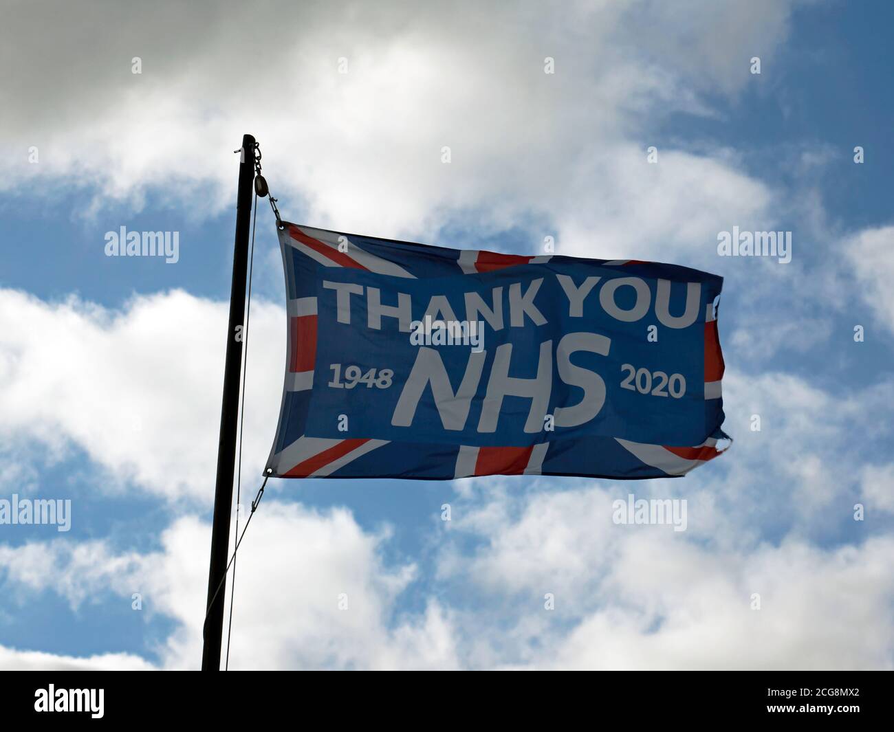 Close-up of a Large Flag on top of a Beach Hut, in Deal,  with a message thanking the NHS for its service especially during the 2020 Covid-19 Pandemic Stock Photo