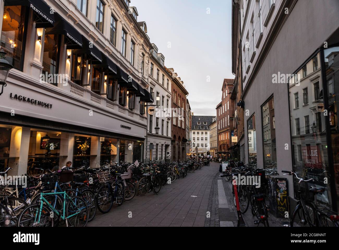 Copenhagen, Denmark - August 26, 2019: Street full of parked bicycles in the old town of Copenhagen, Denmark Stock Photo
