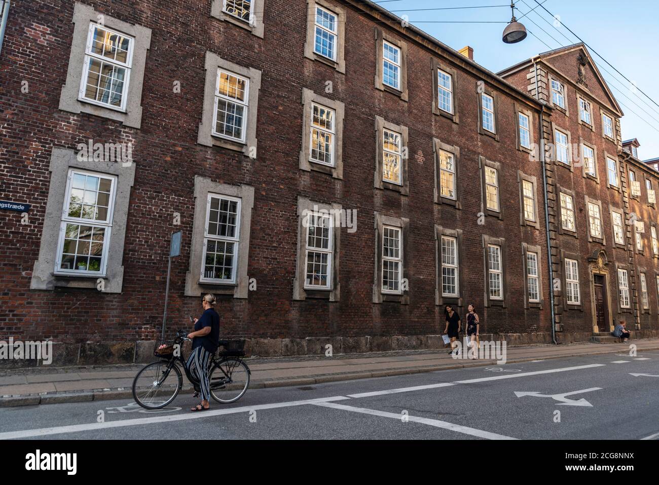 Copenhagen, Denmark - August 26, 2019: Street with people on bicycle and walking in the old town of Copenhagen, Denmark Stock Photo