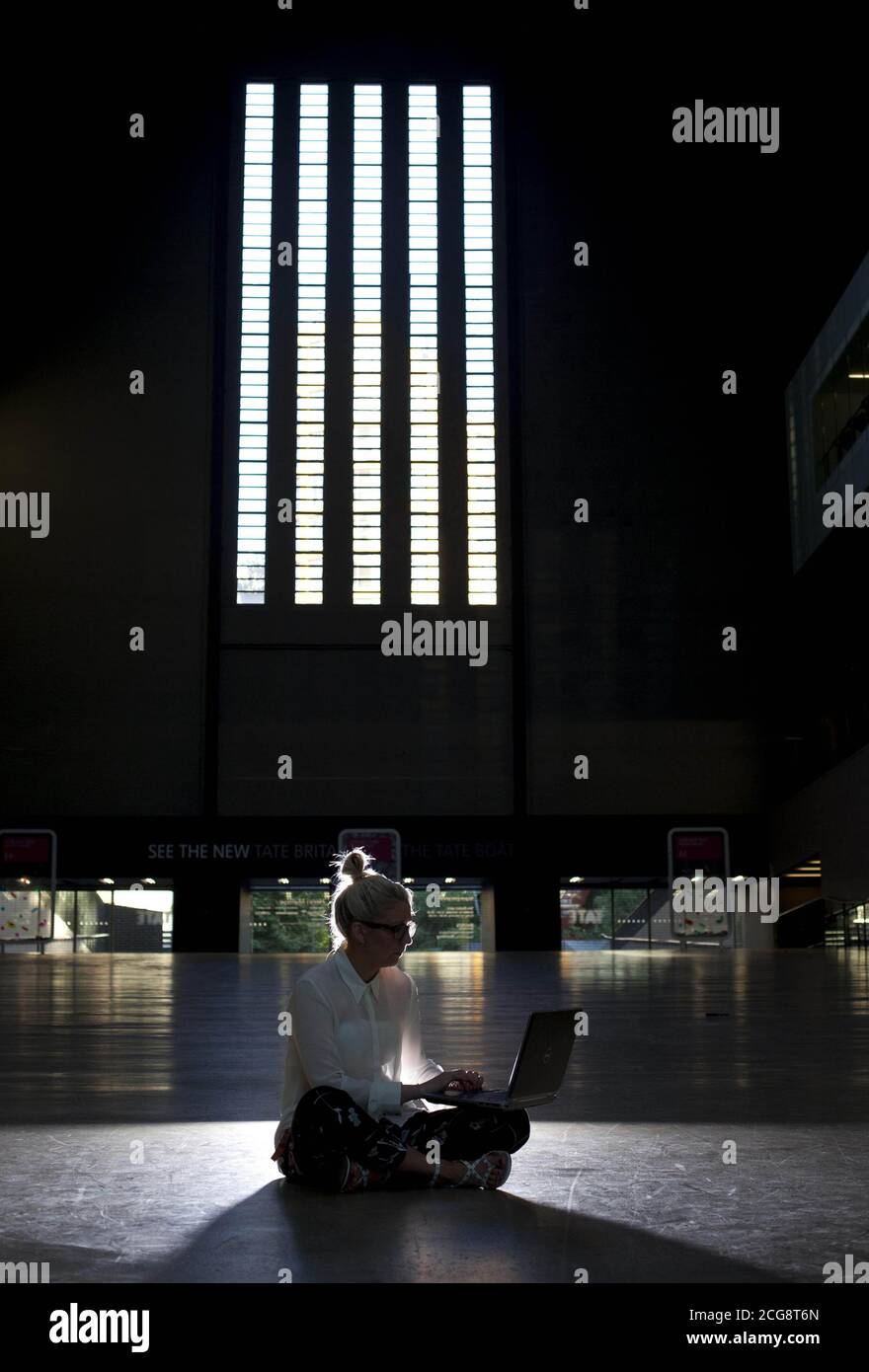 Workmen prepare the venue ahead of Hack The Space, the first ever 'hackathon', which will be held tonight in the Turbine Hall at Tate Modern in London, to launch The Space - a free website for artists and audiences around the world to create and explore digital art. Stock Photo