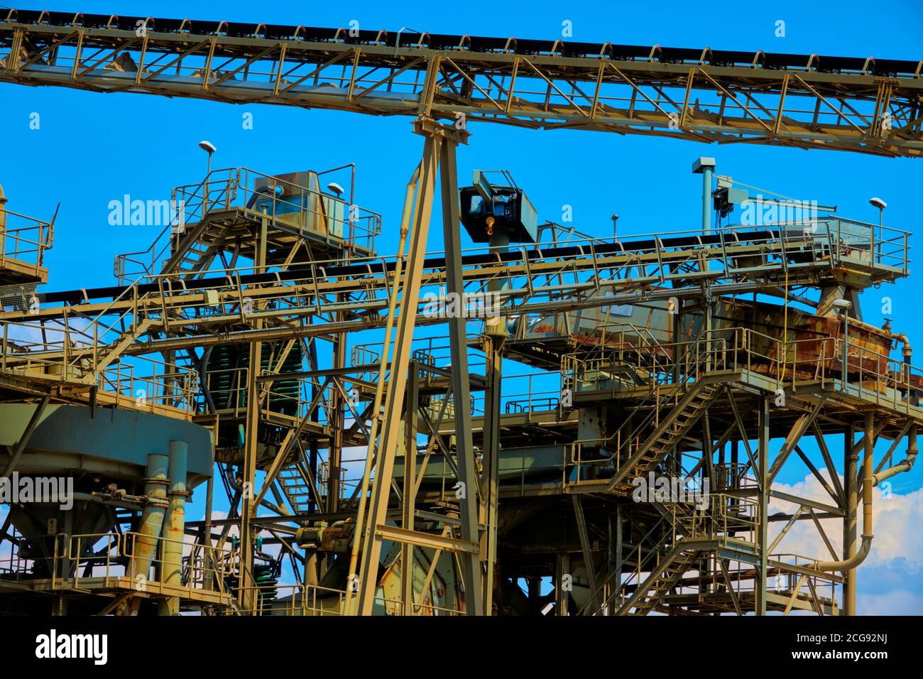 Conveyor belts in front of the collection warehouse of a sand mining company in Germany Stock Photo