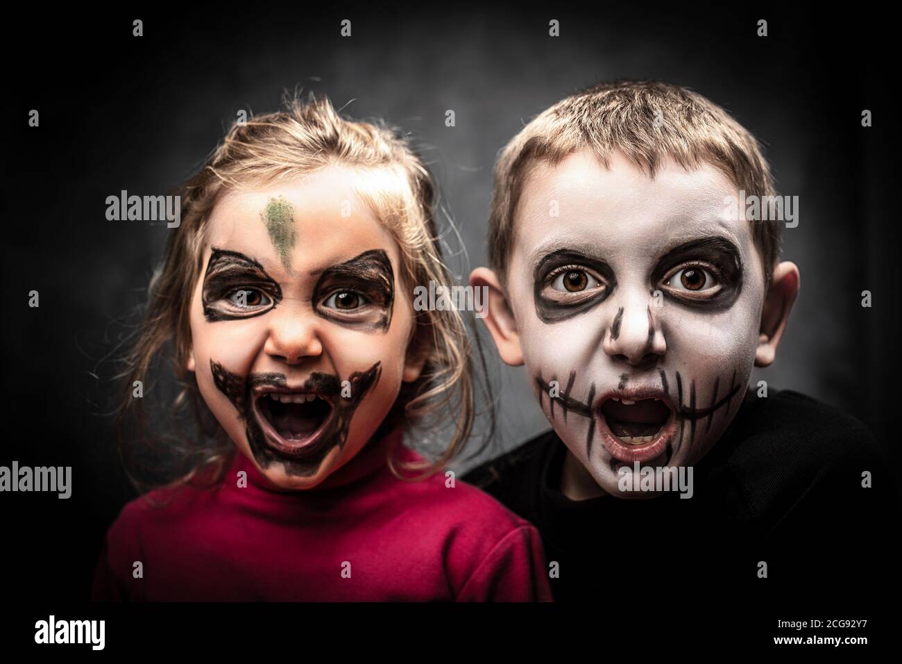 children with face made up for halloween party. studio shot. Stock Photo