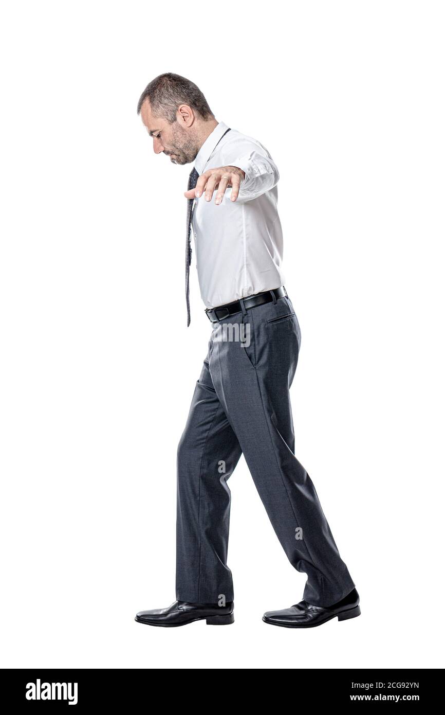 businessman walks keeping balance isolated on white. Stock Photo