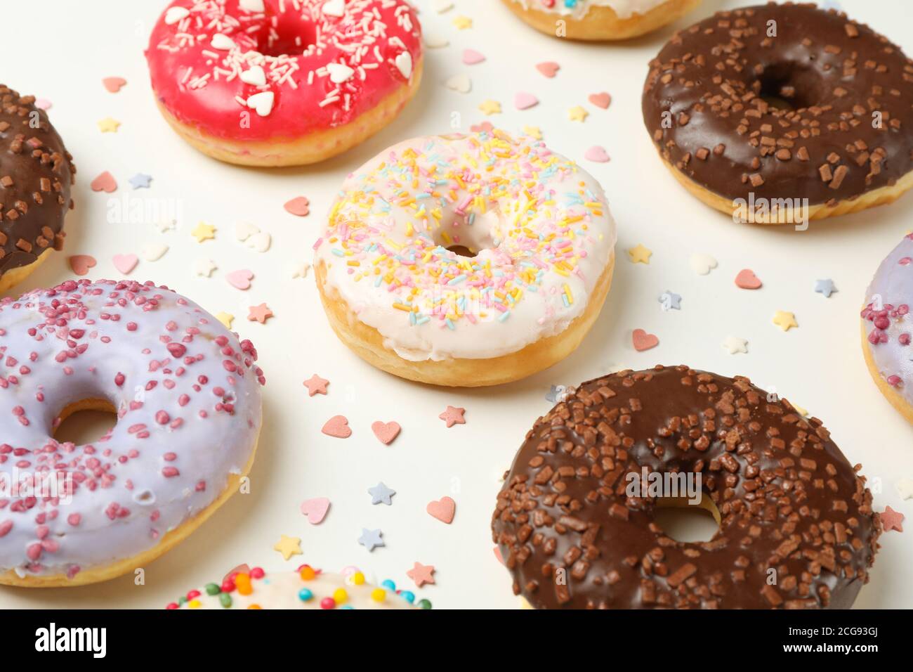Flat lay with tasty donuts on white background Stock Photo