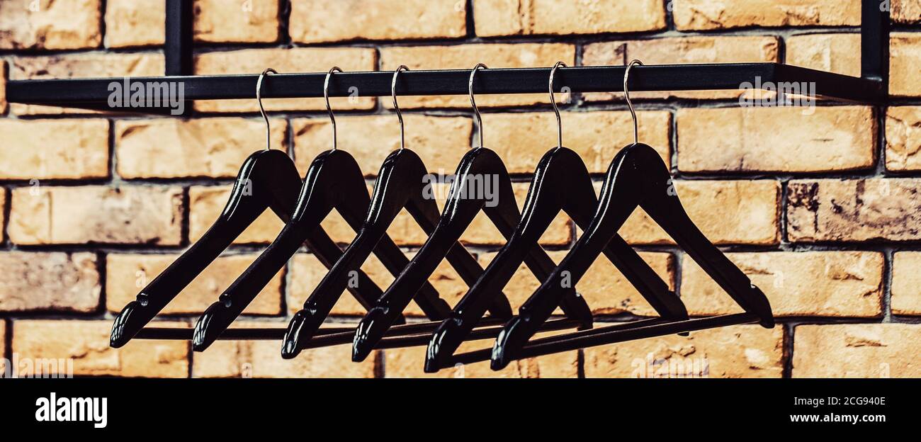 Wooden coat hanger clothes. Fashionable different types of hanger. Many wooden black hangers on a rod. Store concept sale design empty hangers Stock Photo Alamy