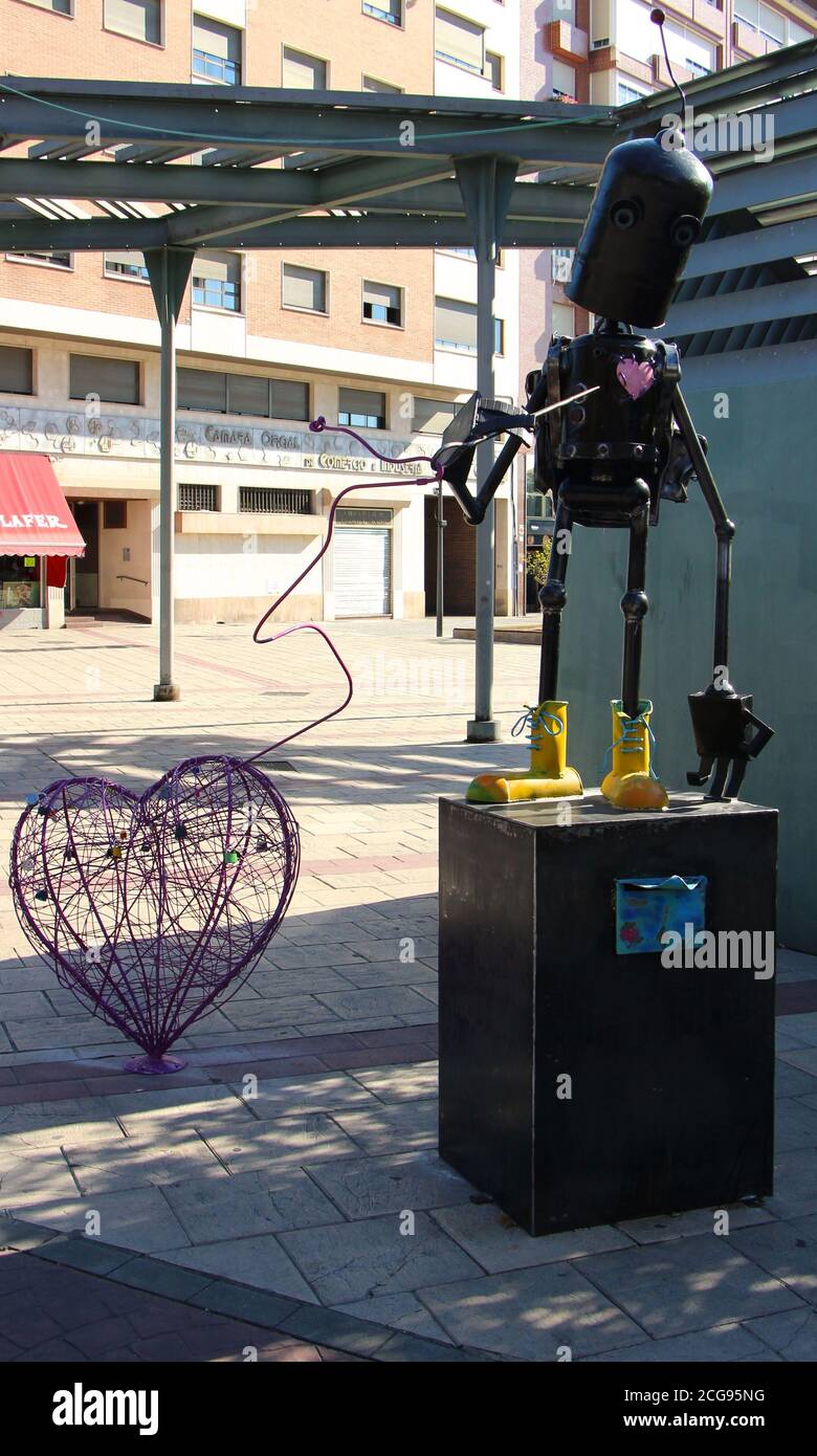 Modern art sculpture Metal robot on a pedestal with a letter box holding  heart made from wire with padlocks attached Palencia Castile and Leon Spain  Stock Photo - Alamy