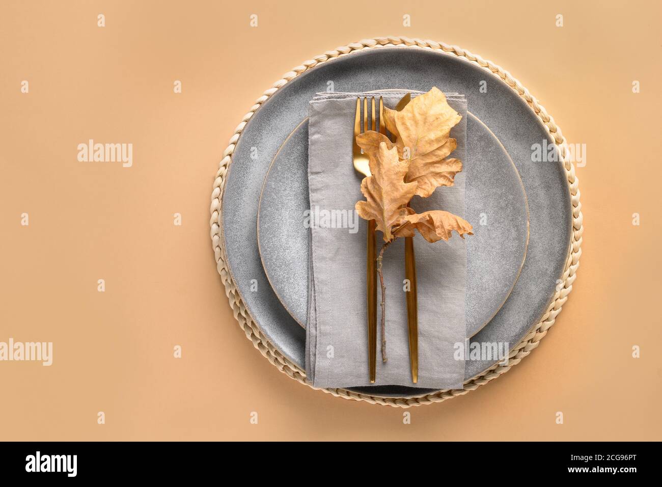 Fall table setting with golden cutlery decorated autumn oak leaf on ...