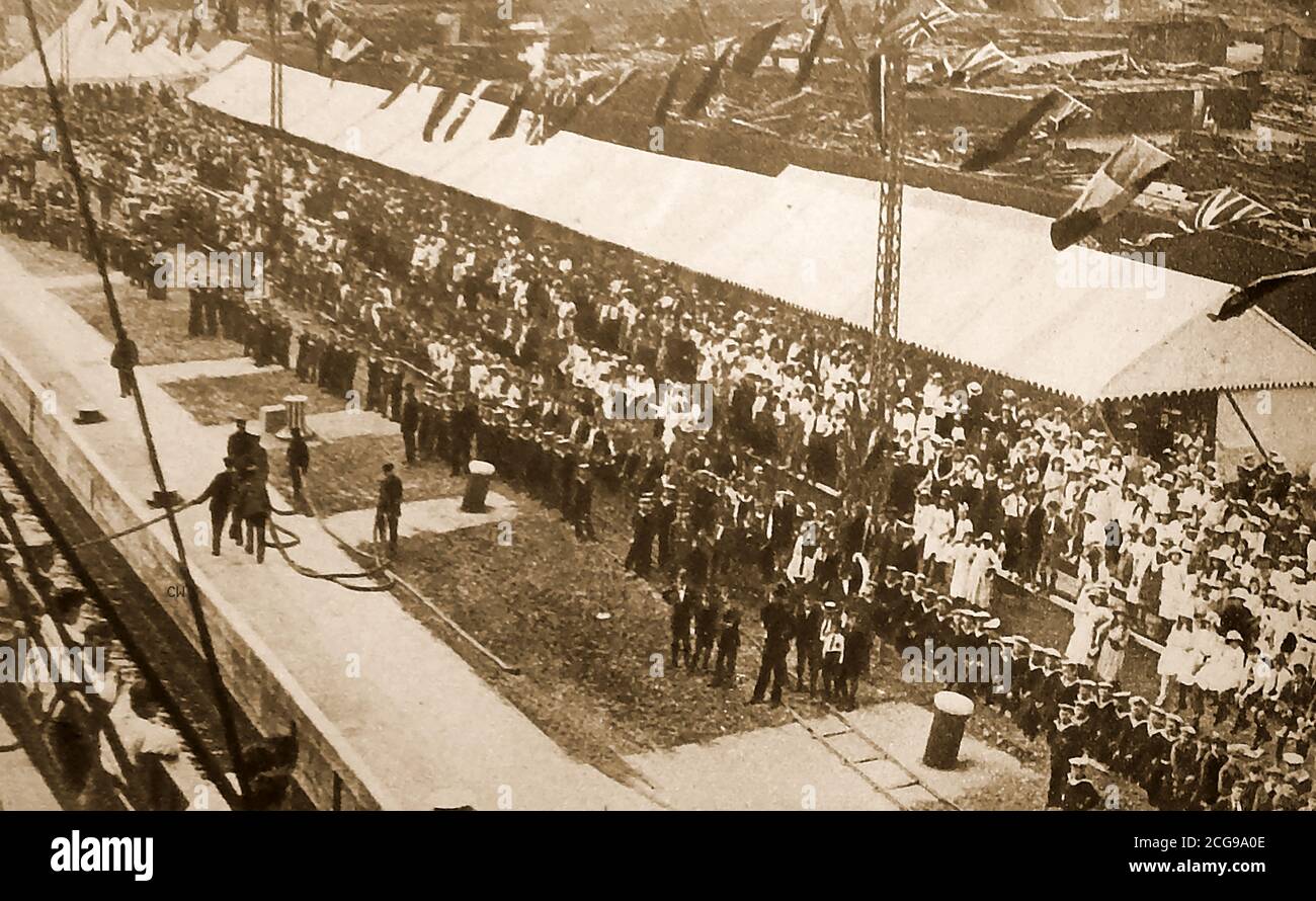 Opening of the Royal Docks in London  in July 1921  -  This the third and final dock of London’s Royal Docks was officially opened by King George V on July 8, 1921. It cost  £4.5million  and covered 64 acres of land. Over 1,500 people were employed on the construction of the docks, twelve of which lost their lives in the process.  The port was equipped with electric cranes  storage areas and refrigeration facilities. Goods  such as  frozen meat,  fruit, vegetables & grain regularly  passed through the dock in the years that followed and larger ships such as the Mauretania could be accommodated Stock Photo