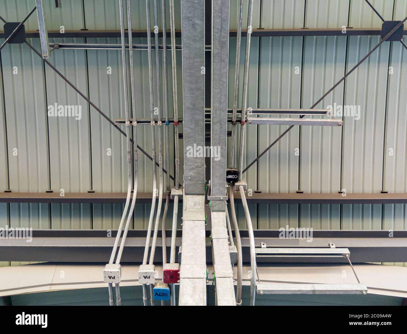 https://c8.alamy.com/comp/2CG9A4W/metal-pipe-row-and-metal-tray-of-the-electric-system-on-the-ceiling-of-the-urban-train-station-under-construction-2CG9A4W.jpg