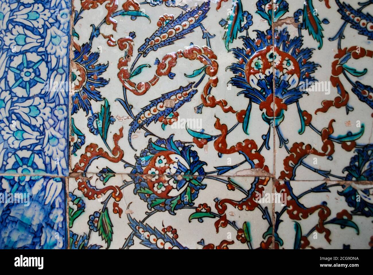 Beautiful antique tile ceramic art with floral decoration painted in blue, red and turquoise colors on a wall in Topkapi palace. Istanbul Turkey Stock Photo