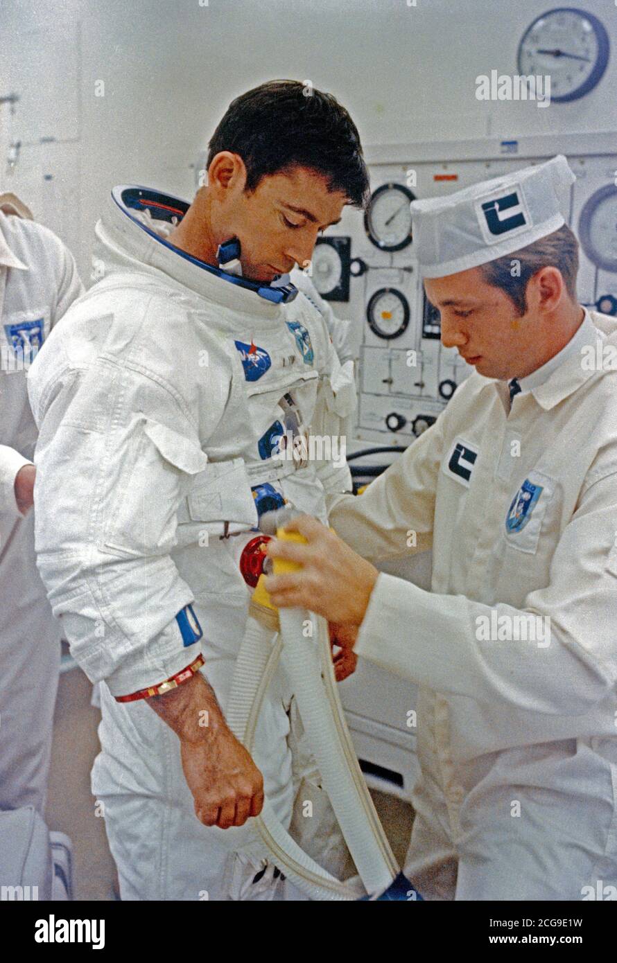 (18 May 1969) --- A technician attaches hose from test stand to spacesuit of astronaut John W. Young, Apollo 10 command module pilot, during final suiting operations for the Apollo 10 lunar orbit mission. Stock Photo