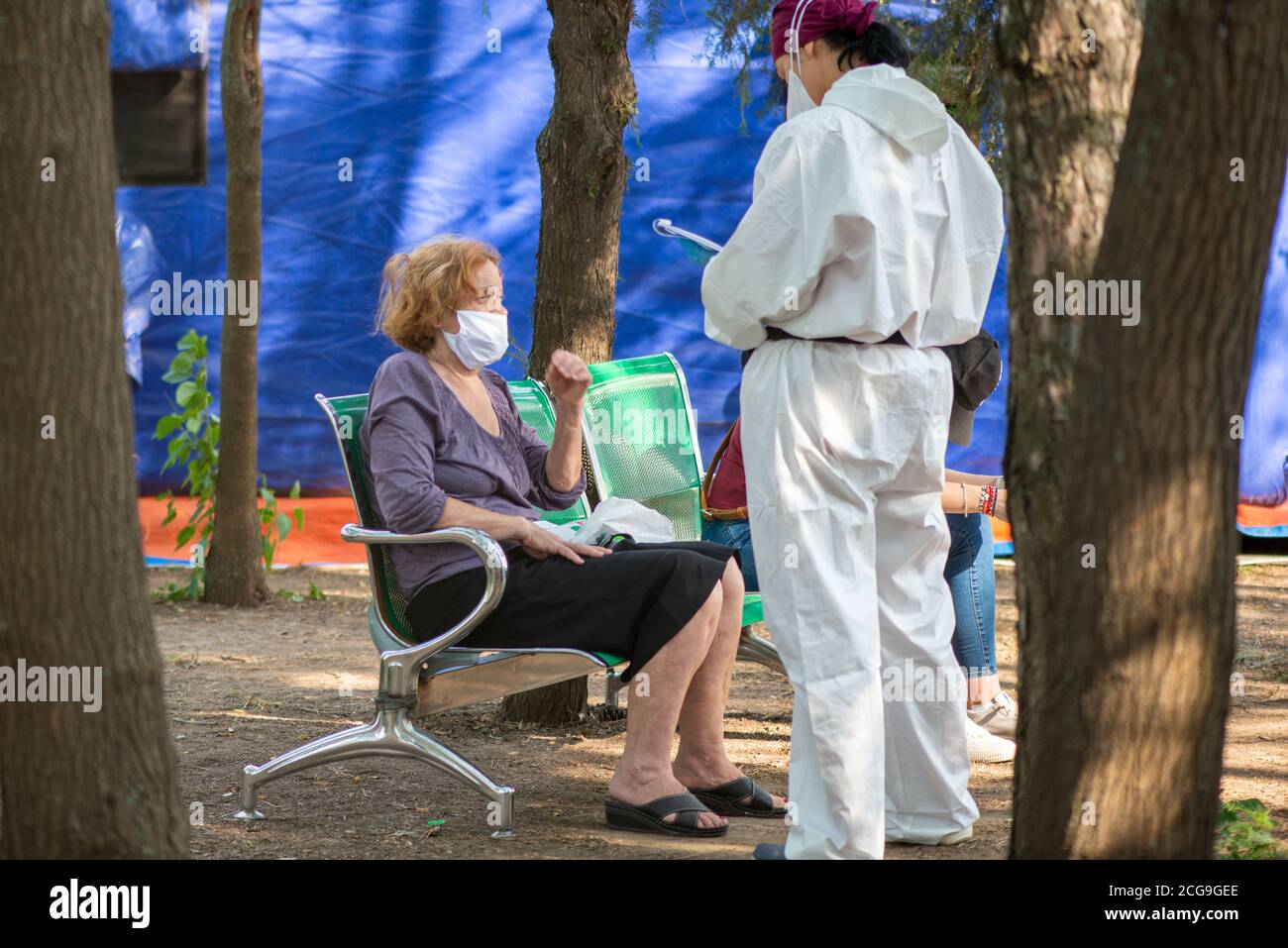 Galati, Romania, July 23, 2020: Old woman and doctor during COVID-19 epidemic, coronavirus testing point in front of the hospital Stock Photo