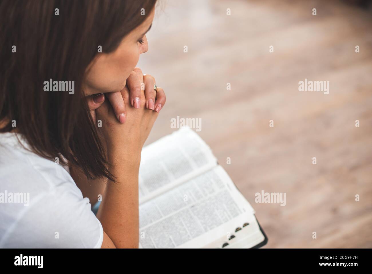 young woman pray with bible relationship with God at home Stock Photo