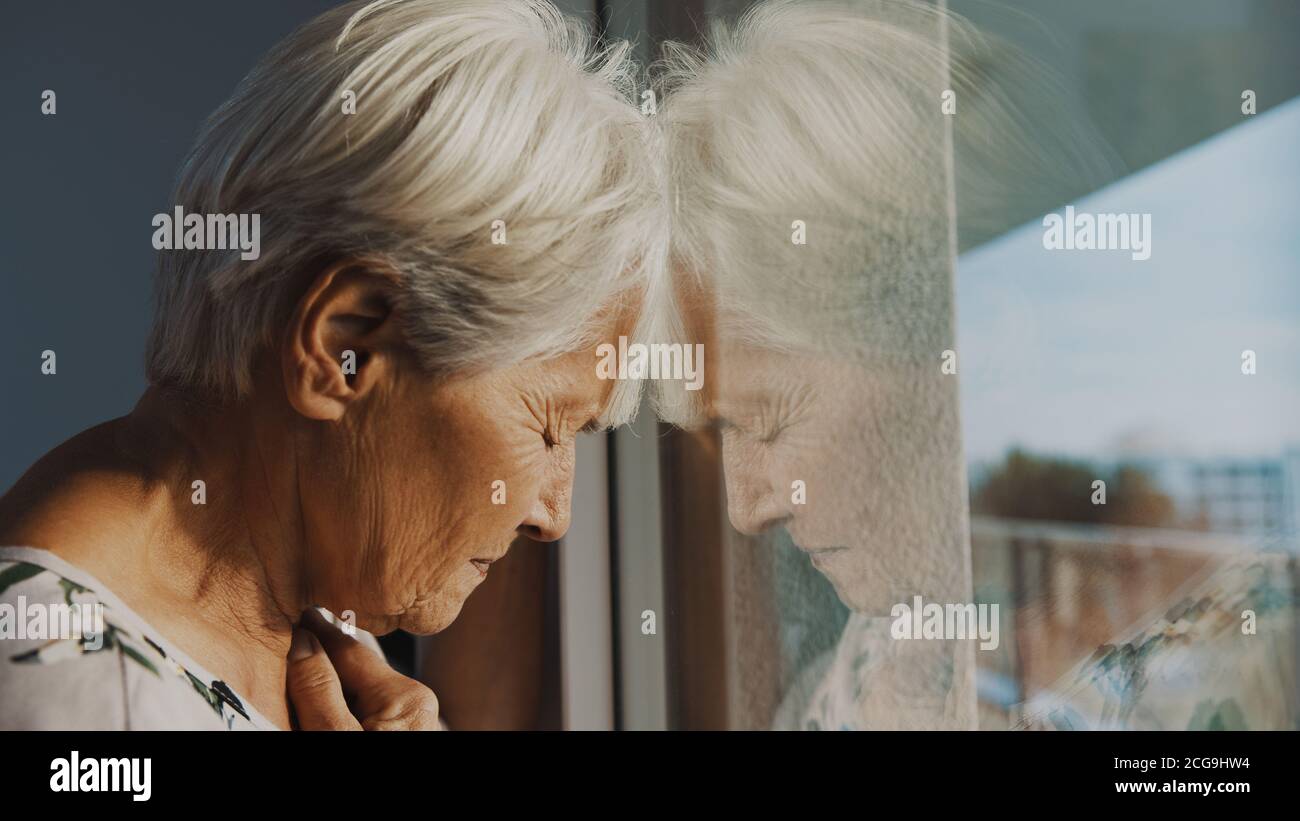 hopeless elderly woman, feeling loneliness during the lockdown. Vulnerable group and mental health issues. High quality photo Stock Photo