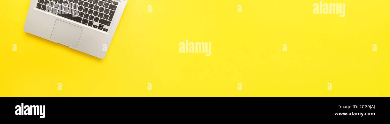 Keyboard laptop computer isolated on yellow desk background. Modern ...