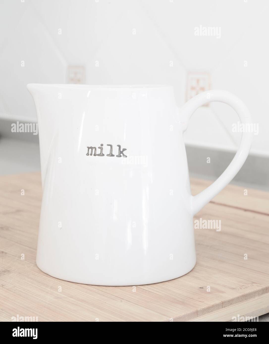 Smooth pristine white porcelain jug of milk Stock Photo