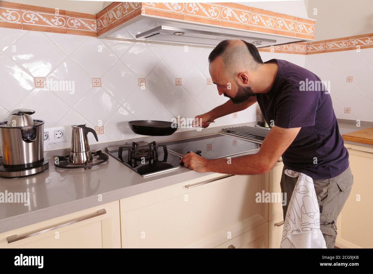 Young hispanic self-sufficient man about to cook Stock Photo