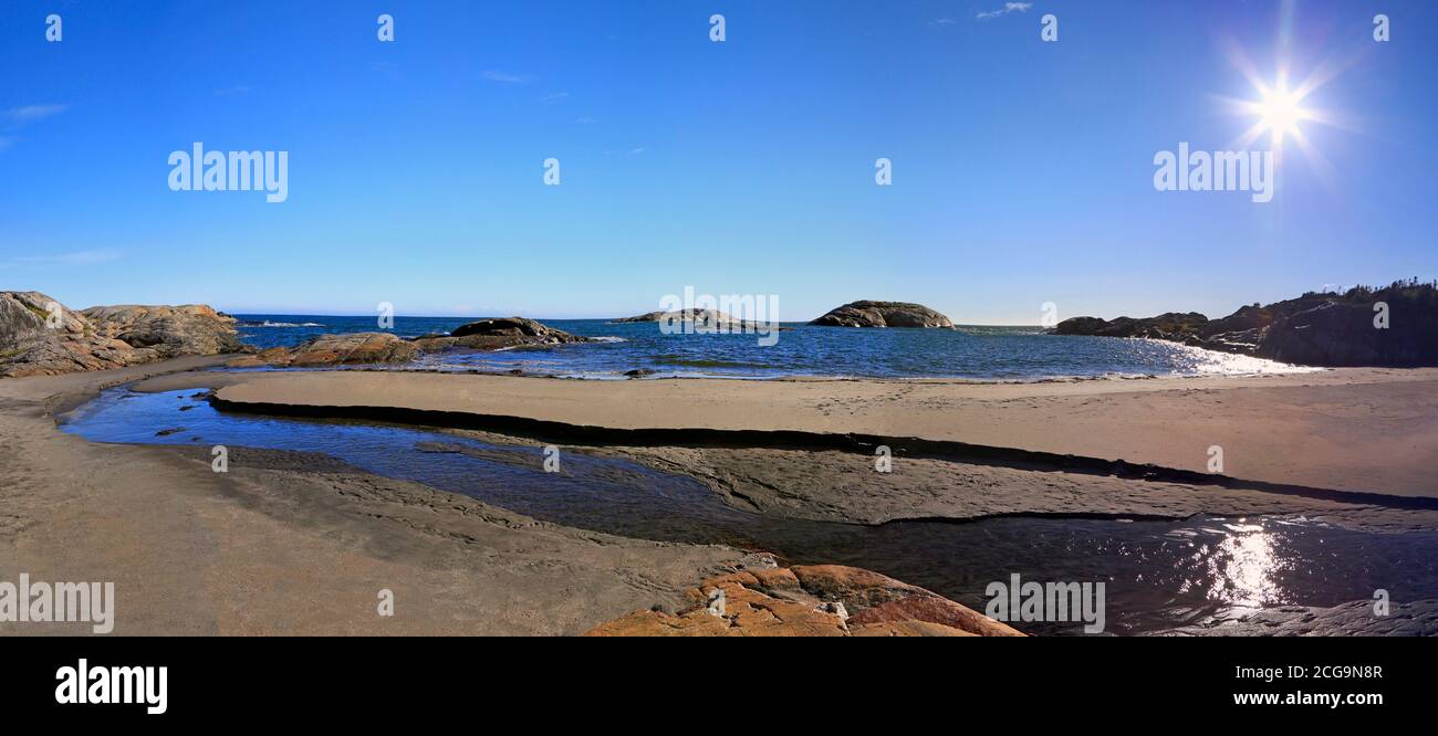 Rocky Bay beach, river and islands of Saint Lawrence Estuary in Riviere-au-Tonnerre area, Cote-Nord, Quebec Stock Photo