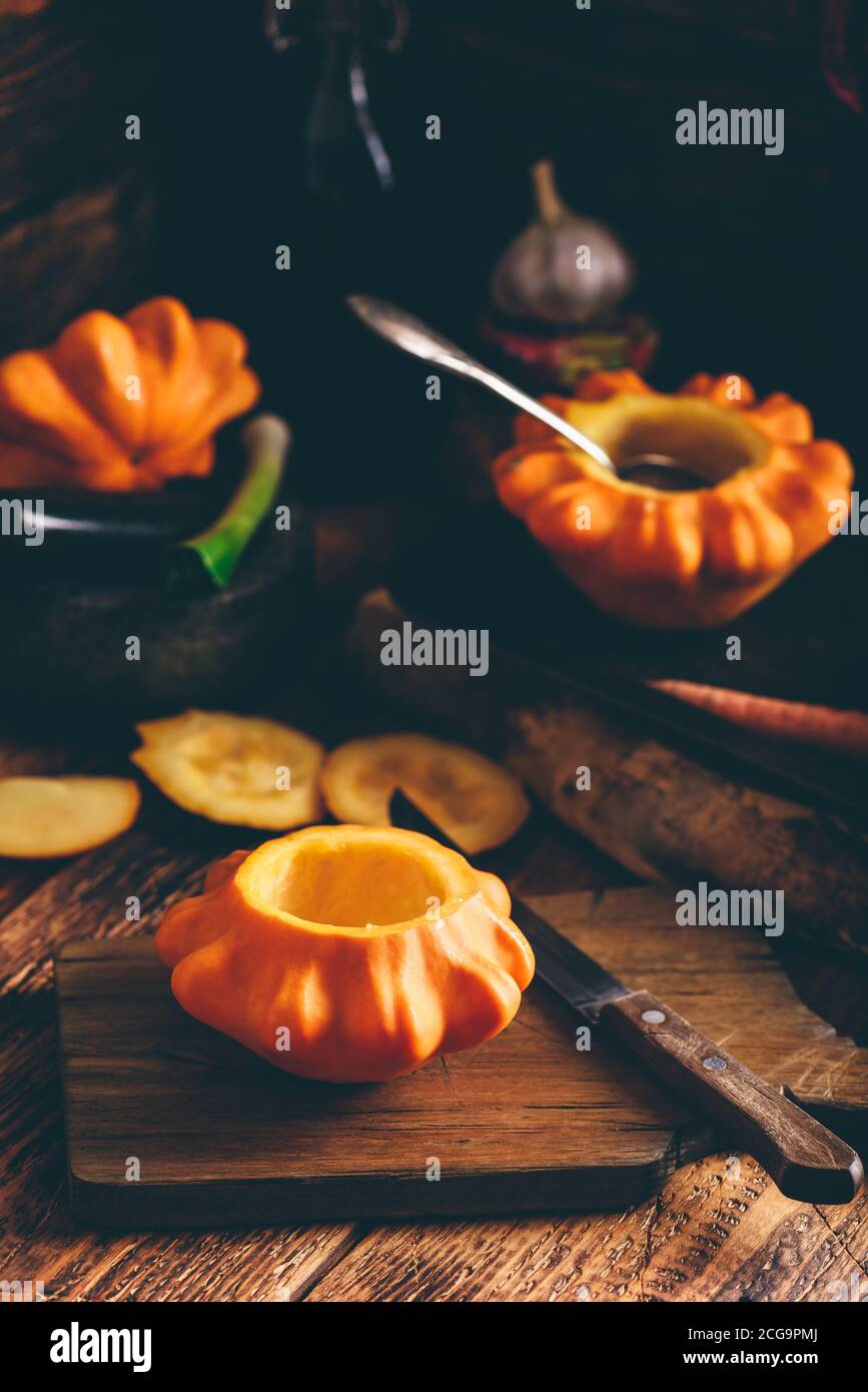 Preparing yellow pattypan squash for stuffing Stock Photo