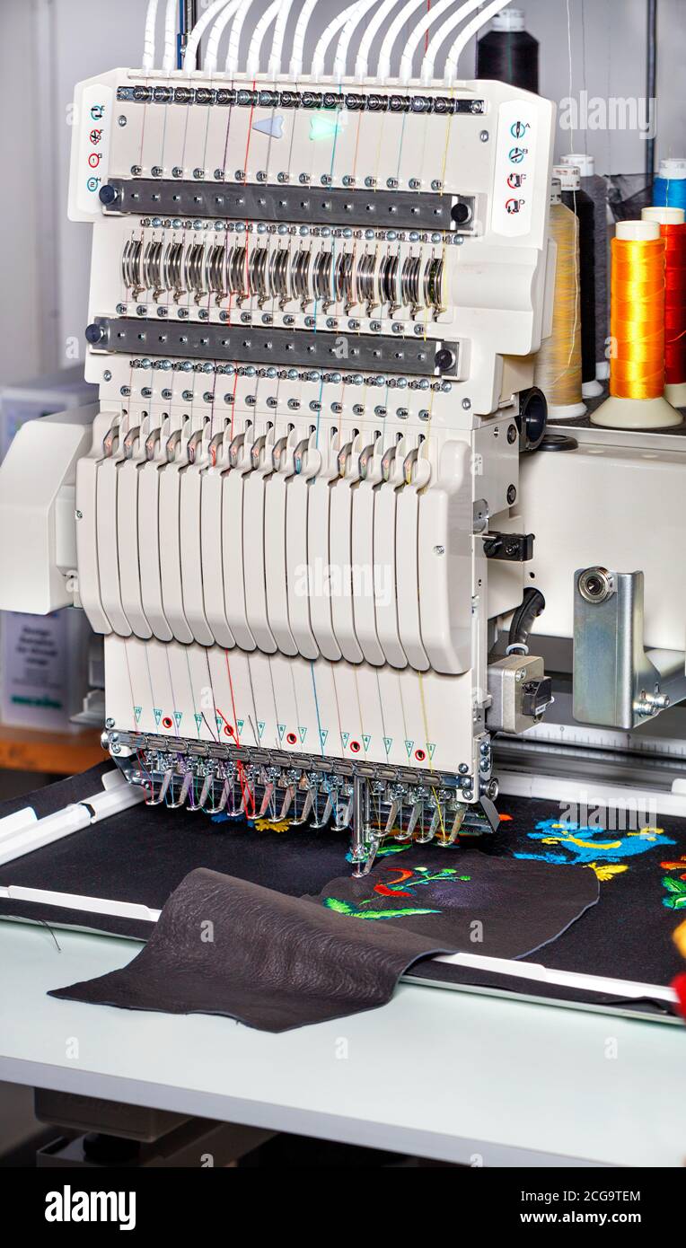 Industrial embroidery machine with multicolored threads, closeup