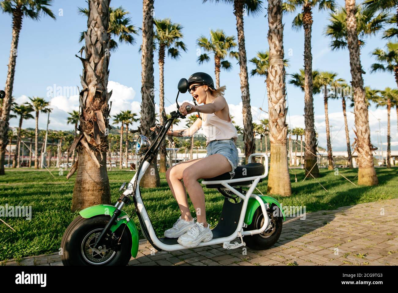 EBike Rider girl riding on bike trail on Sunday morning. Pretty joyful