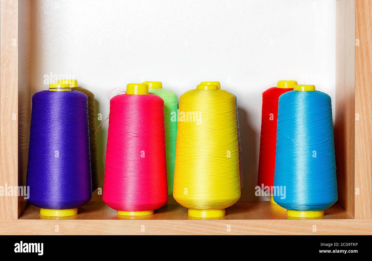 Bobbins of multicolored silk threads for embroidery and professional embroidery machines. Stock Photo