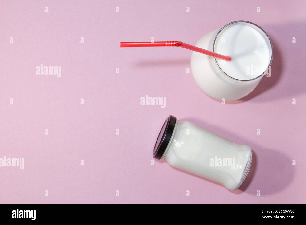 Airan or kefir drink, fermented milk drink, fermented probiotics on a pink background with copy space. Healthy food concept. Top view. Stock Photo