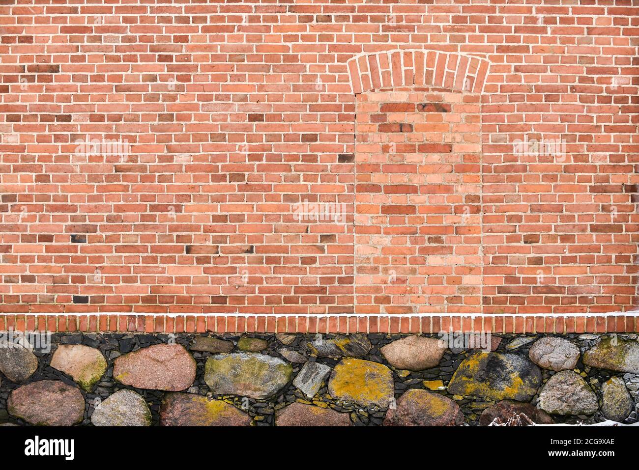 Old wall from bricks and large stones Stock Photo