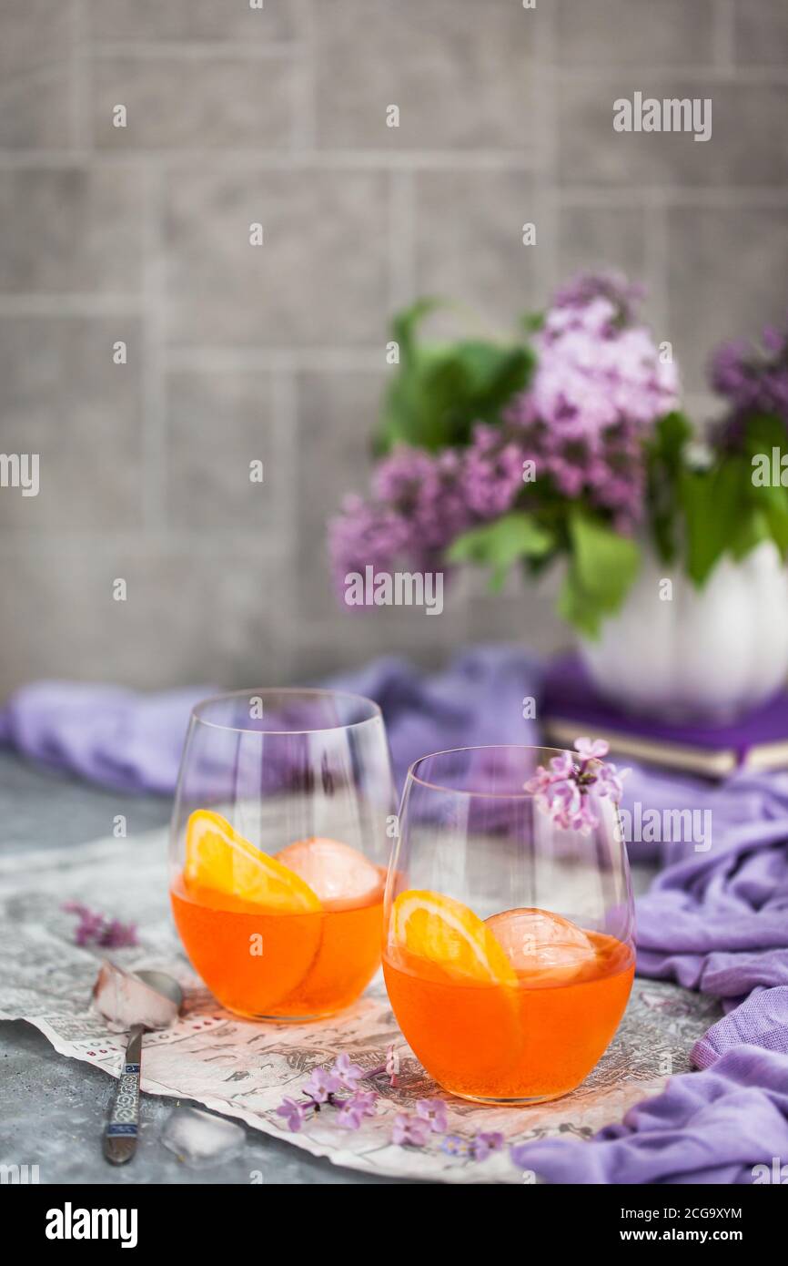 Orange Aperol Spritz cocktail served in a wine glasses, decorated with ...