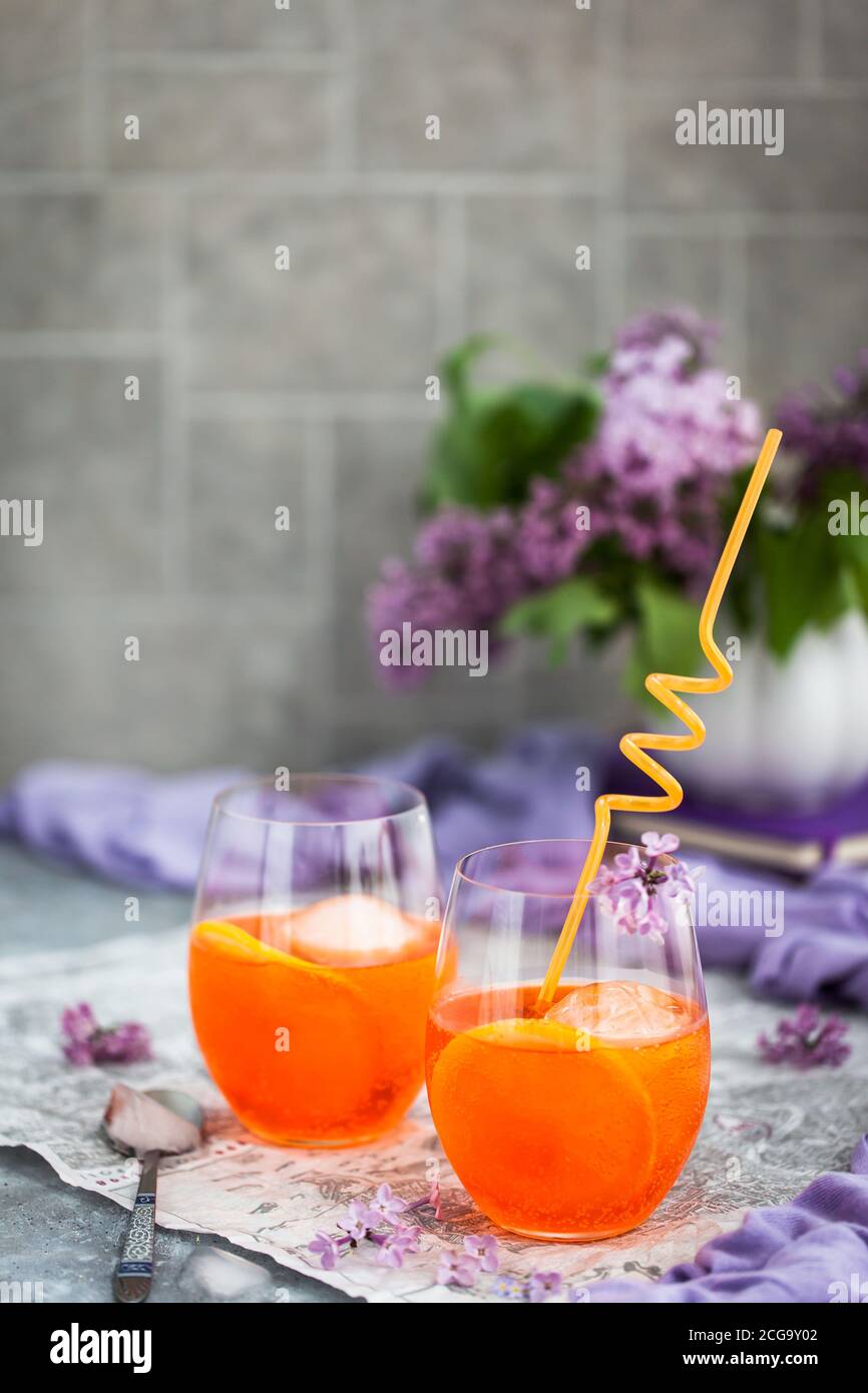 Orange Aperol Spritz cocktail served in a wine glasses, decorated with ...