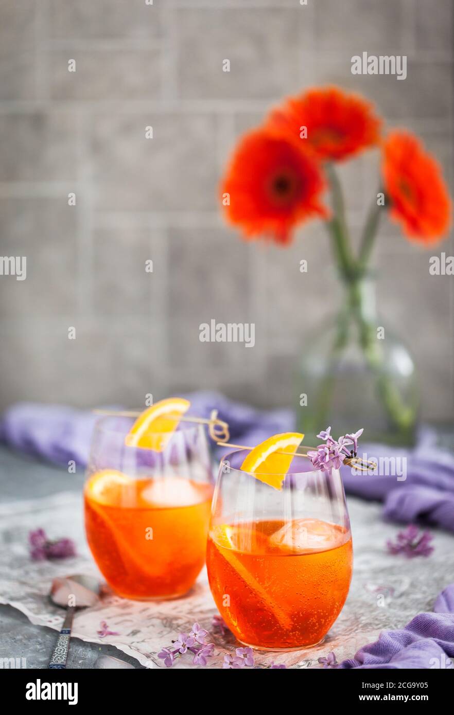 Orange Aperol Spritz cocktail served in a wine glasses, decorated with ...