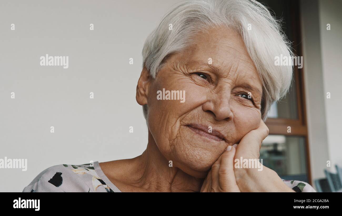 thoughtful senior woman with smile looking in the distance. Portrait with copy space. High quality photo Stock Photo