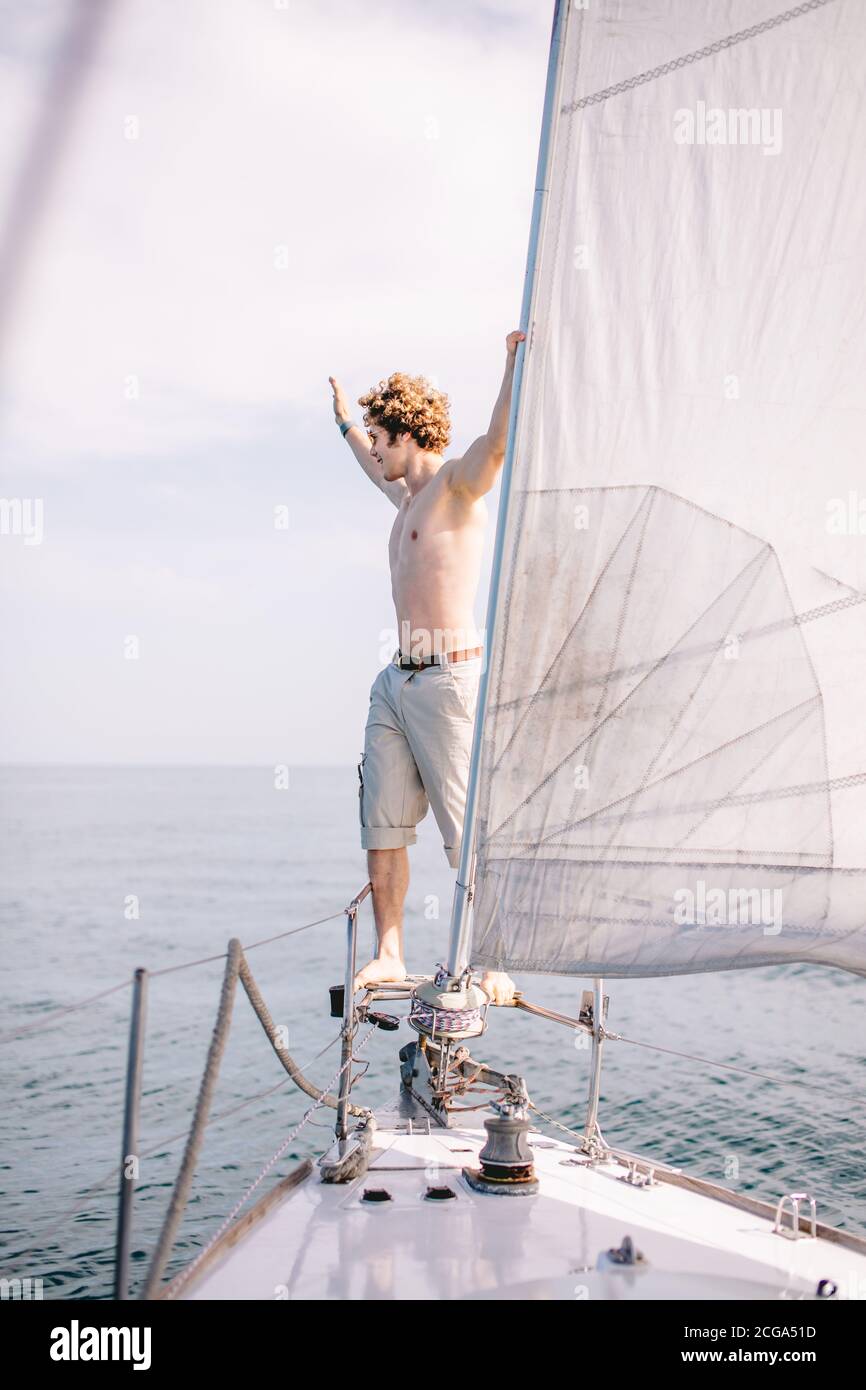 Young handsome tourist or traveller man with red curly hair, enjoying a