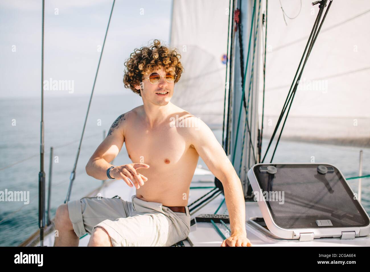 Young red-head man with frizzy hair relaxing happily on the vacation