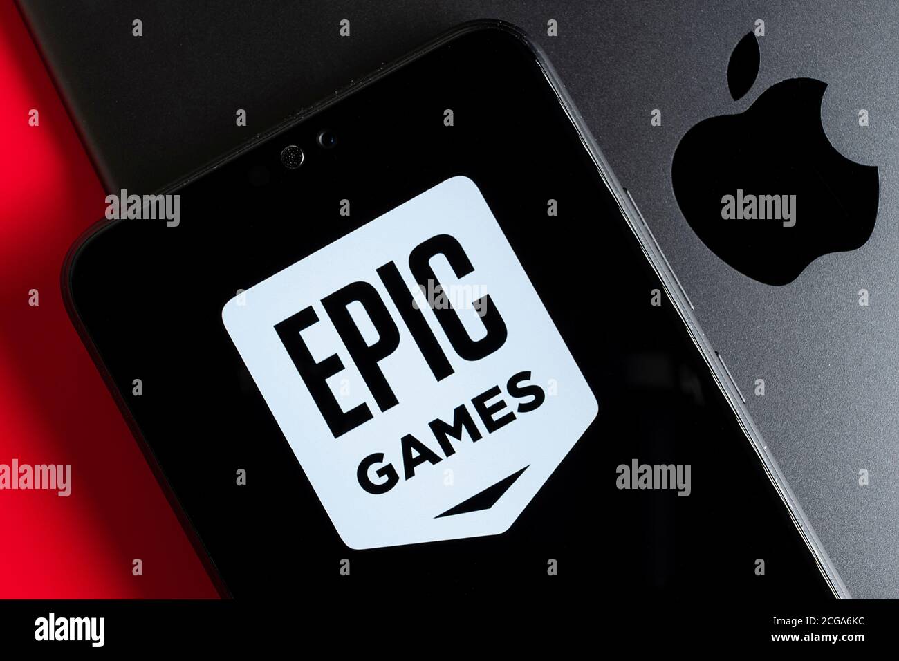 Stone / UK - September 9 2020: Fortnite Epic Games  logo on the mobile phone placed on Apple ipad. Epic Games vs Apple lawsuit concept. Stock Photo