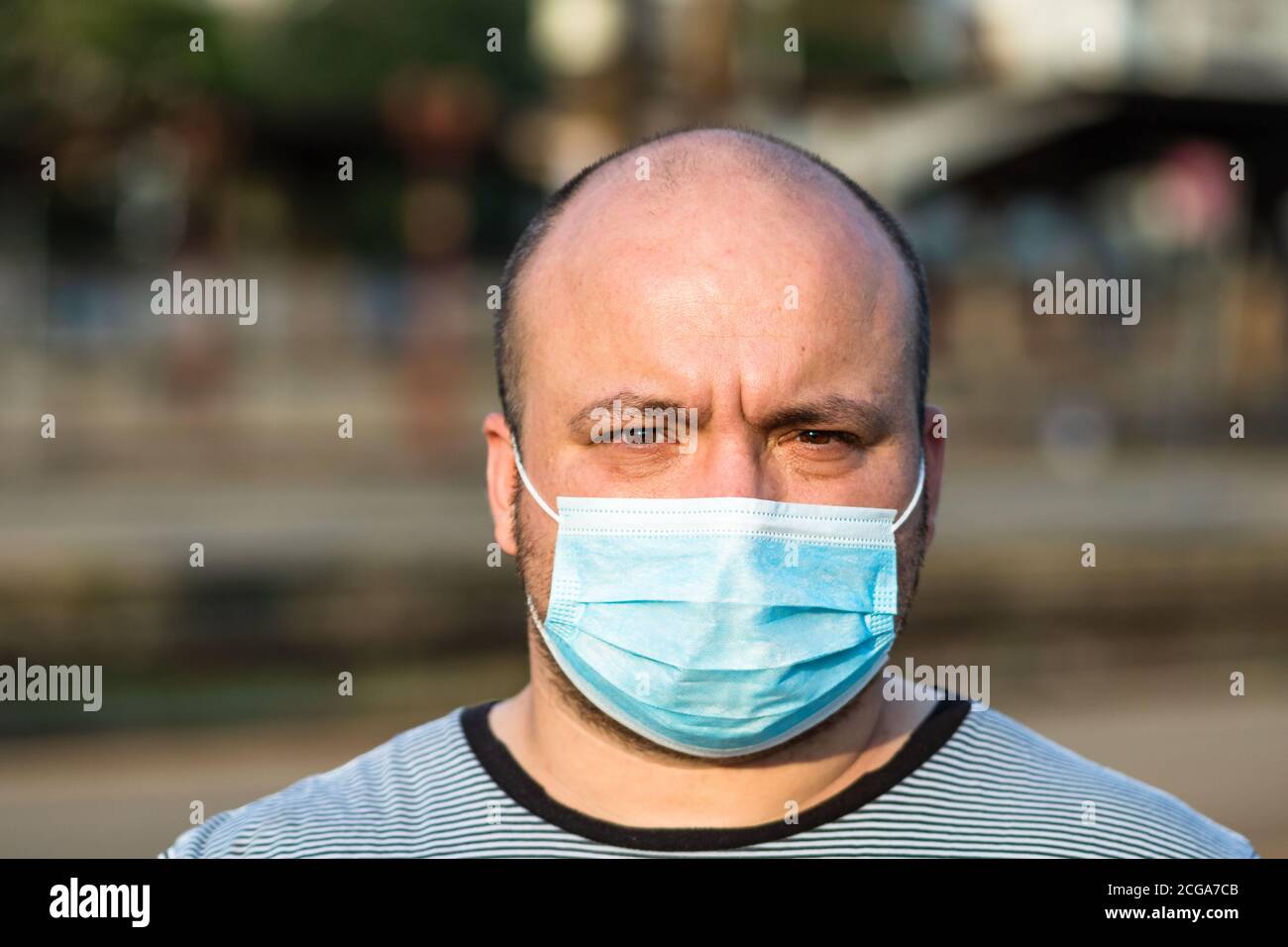 Young man with medical protective face mask illustrates pandemic ...
