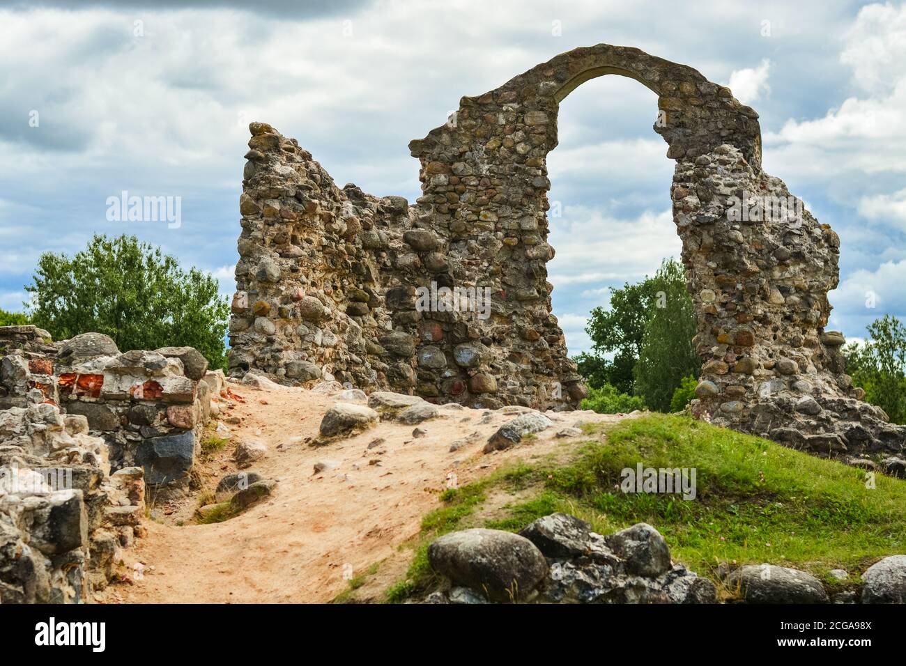 Old historic stone ruins of an ancient castle with a cloudy sky behind ...
