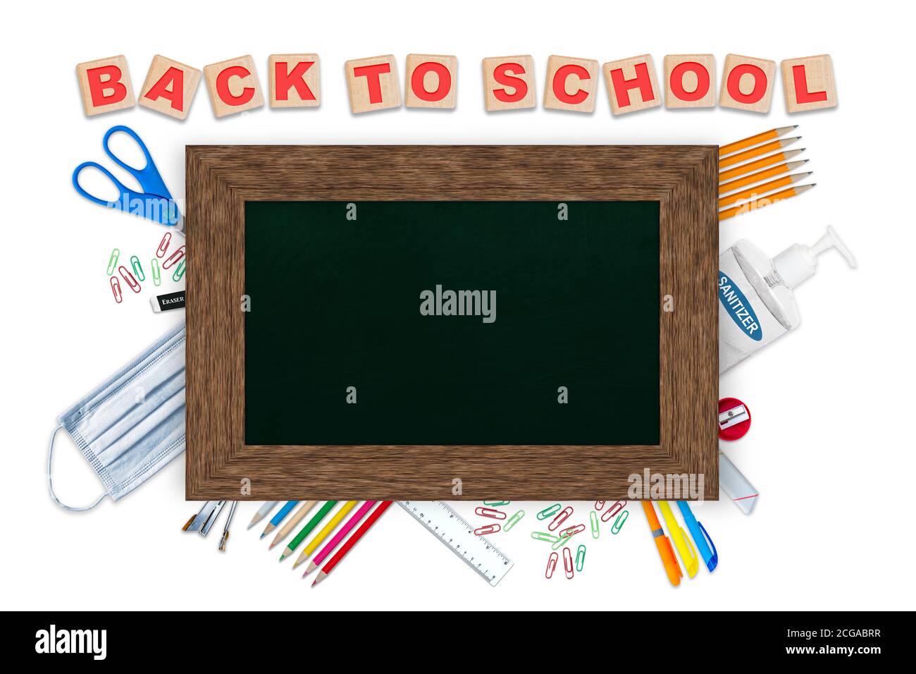 Back to school alphabet blocks, concept of education in the COVID-19 new normal with stationery, hand sanitizer, face mask and chalkboard copy space o Stock Photo