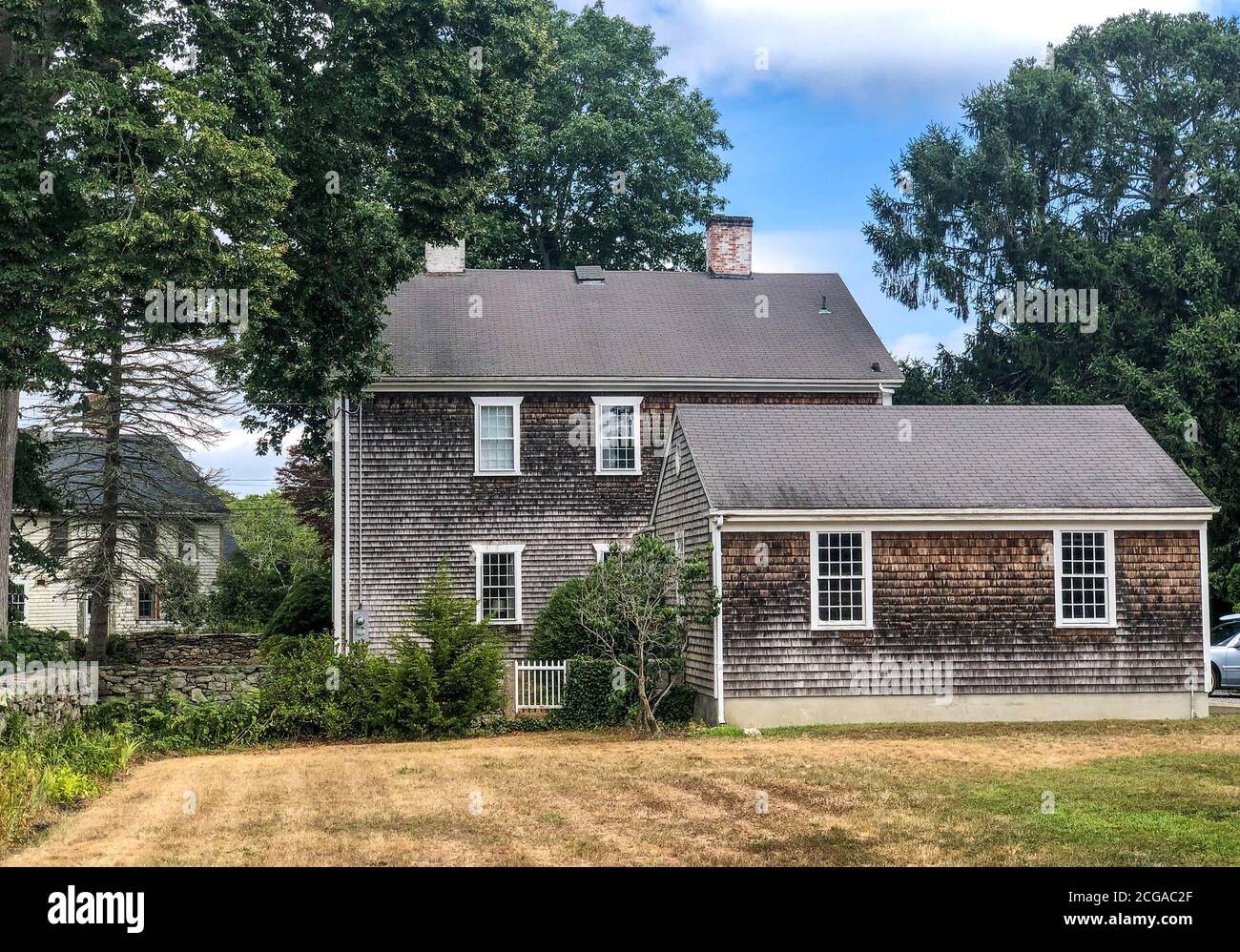 An old Colonial house with weathered wood cedar shake shingles near the