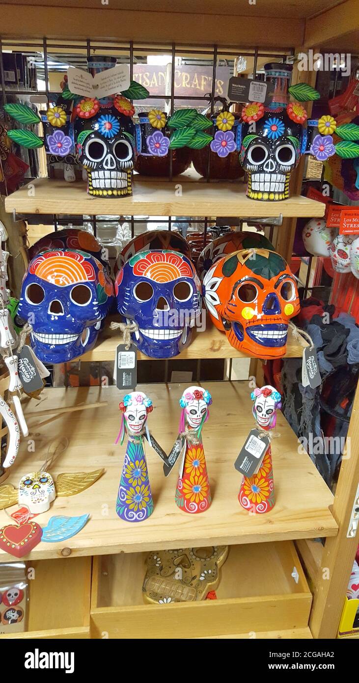 Hand-painted ceramic skulls and dolls on a store shelf, Washington D.C., United States Stock Photo