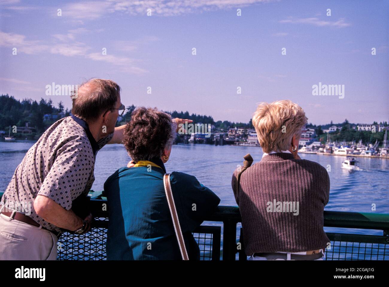 Passengers at railing of ferry boat arriving at Friday Harbor on San Juan Island, Washington USA Stock Photo