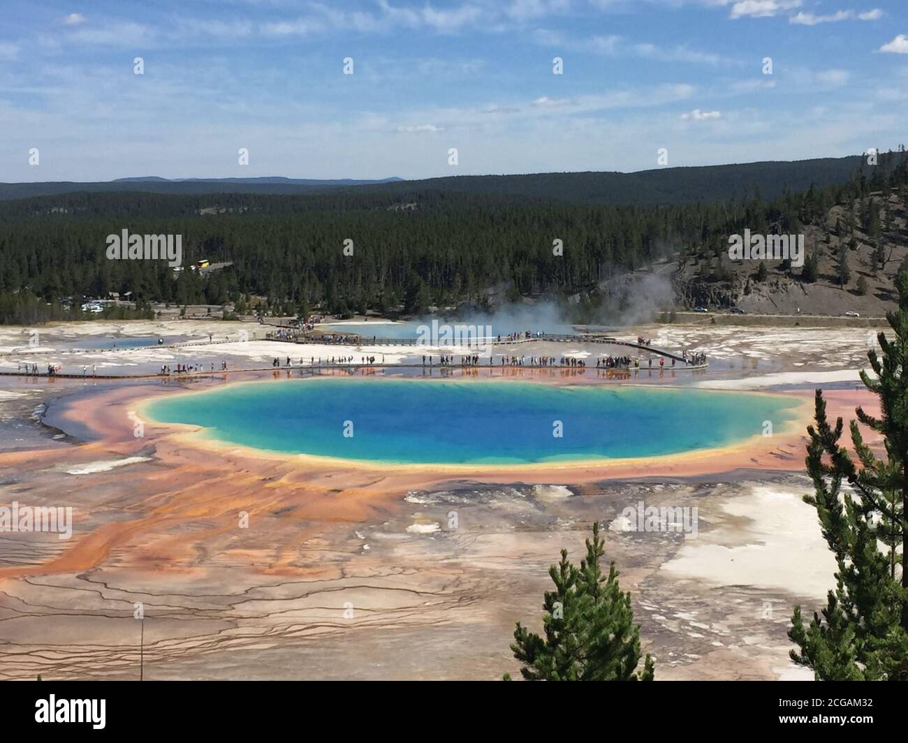 Famous trail of Grand Prismatic Springs in Yellowstone National Park from high angle view. Beautiful hot springs with vivid color blue green orange Stock Photo